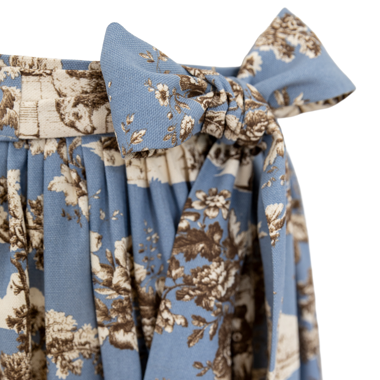 Dirndlschürze Antonia in Rauchblau mit sepiabraunem Toile de Jouy Landleben-Muster und großer Schleife Detailbild