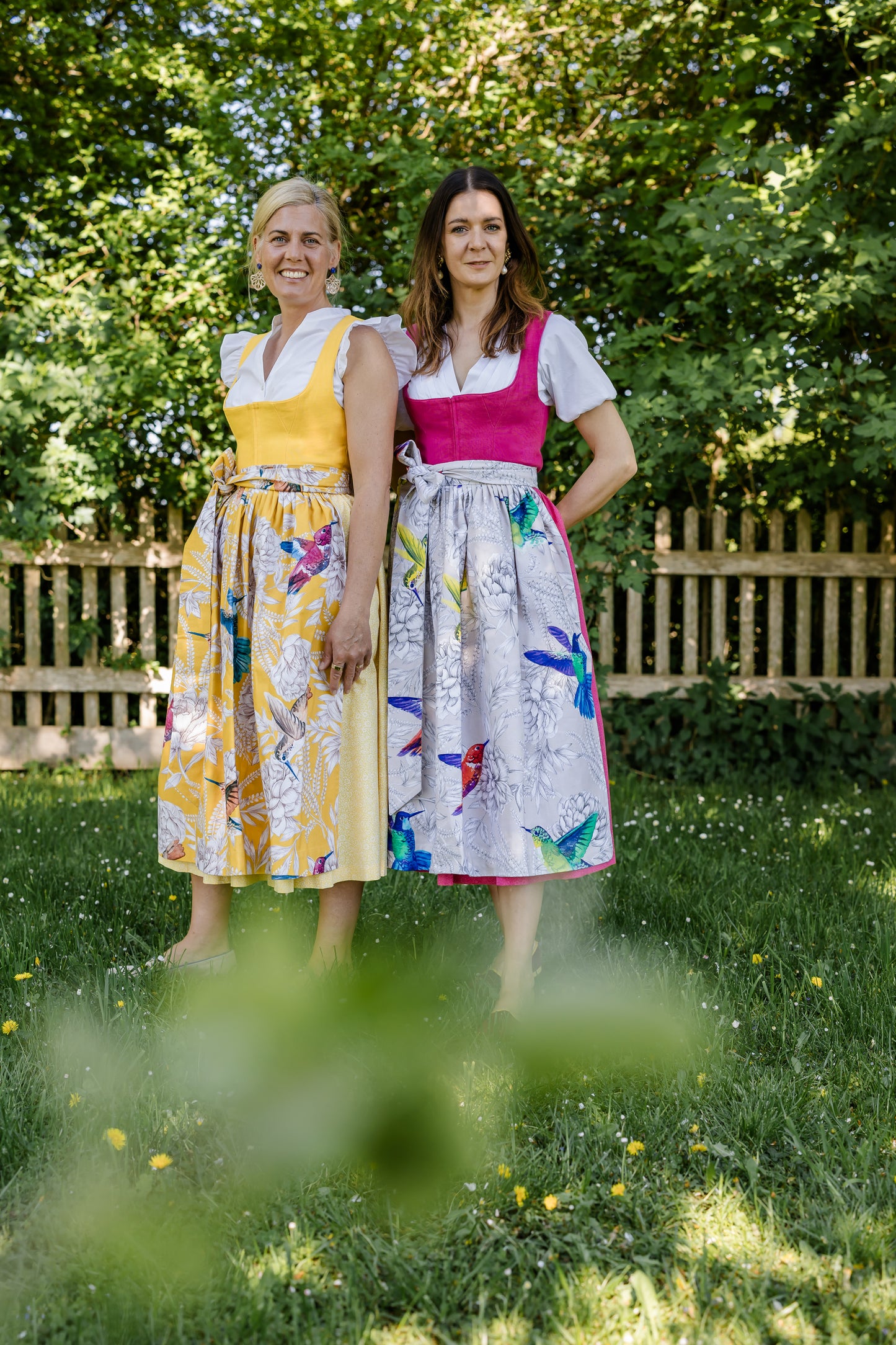 Gelbes Dirndl mit gelber Schürze und Pinkes Dirndl mit Taupe Schürze